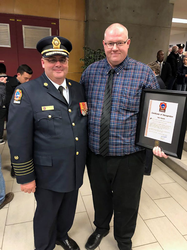 Neil Hignett, health, safety and environmental manager at EllisDon, was presented with a Certificate of Recognition by the Toronto Fire Services for helping to save a life following an incident on a jobsite.