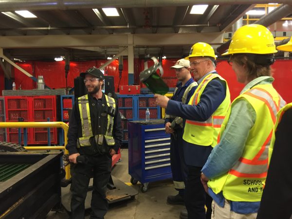 B.C. Government and Services Employees Union faculty steel fabricator Jeremy Cook (left) shows B.C. Premier John Horgan (middle) and Minister of Transportation and Infrastructure Claire Trevena (right) welding techniques taught at the British Columbia Institute of Technology’s Ironworker’s Facility in Burnaby, B.C.