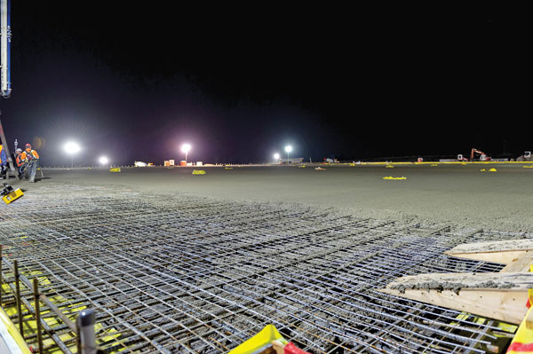 Round the clock concrete pouring at the Canada Royal Milk Plant site in Kingston, Ont. included over 50 trucks making 476 trips between four concrete plants and pouring about 4,289 cubic metres of concrete in a 20-hour period at an average of about 234 cubic metres an hour.