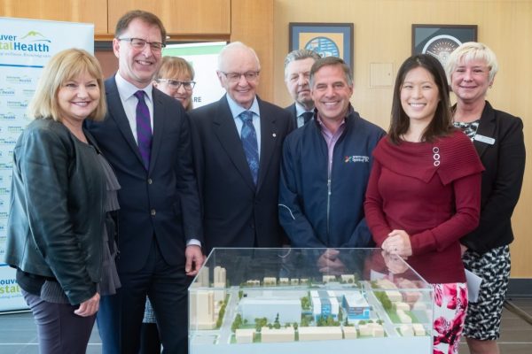 Government officials and donors pose next to a model of Lions Gate Hospital’s new acute care building. The facility will add 108 beds, eight new operating rooms and a medical-device reprocessing department to serve North Vancouver residents.