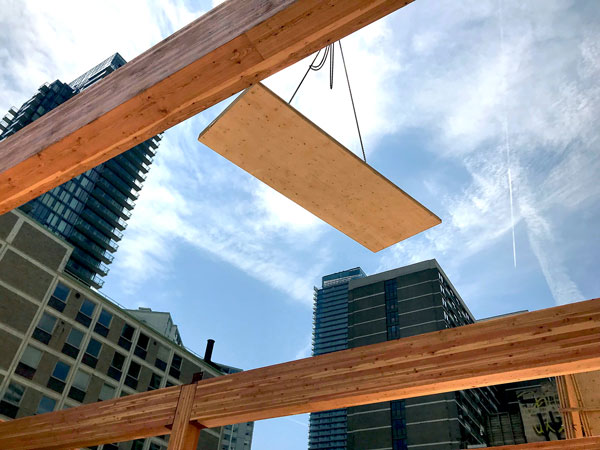 The Timber Systems crew installed 15 to 20, 2.7-metre-by-12.7-metre cross-laminated timber (CLT) panels per day from a truck positioned in a one-lane closure on Charles Street in Toronto. Glulam and CLT products were marshalled at Timber Systems facility in Markham, Ont.