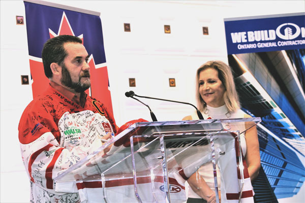 OGCA safety committee chair Craig Lesurf presents a League of Champions jersey to MPP Gila Martow, parliamentary assistant to the minister of labour, at the OGCA safety breakfast on Oct. 26.