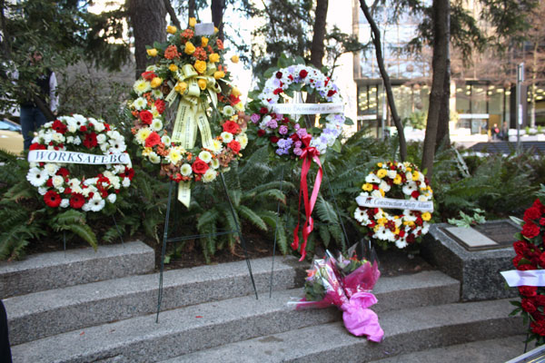 Wreaths from several labour and safety organizations surround the memorial plaque commemorating the lives lost on Jan. 7, 1981.