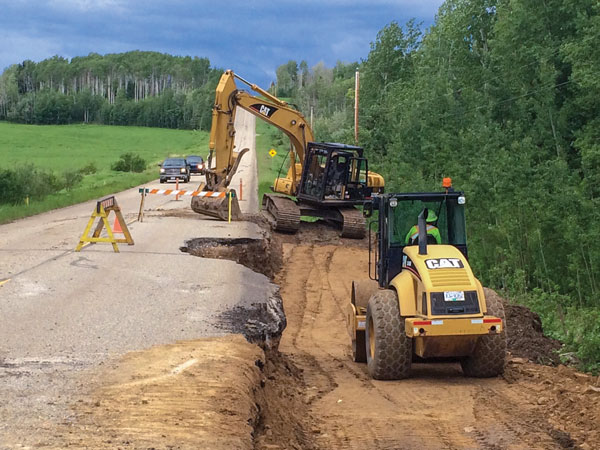 Crews work on Mason-Semple Road in June 2016 after rainfall caused road damage.