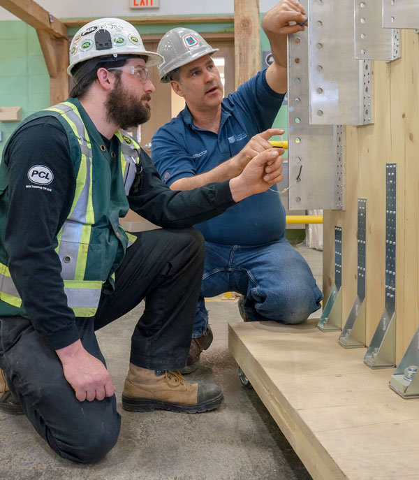 Timber course student Tyler Brayshaw learns the ins and outs of timber construction from course instructor Jason Moreau. The course, put on by the College of Carpenters and Allied Trades, covers timber framing tools and fastening systems as well as methods of installing prefabricated cross-laminated timber walls and ceilings.