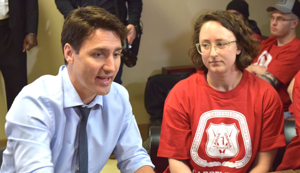 Second-term carpenter apprentice Christine Dewancker listened in as Prime Minister Justin Trudeau discussed Liberal infrastructure and training programs during a visit to the Carpenters’ training headquarters in Woodbridge, Ont. on March 22.