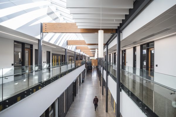 Work on the two-storey, 104,000-square-foot Red River College Skilled Trades and Technology Centre started in August 2015 and finished in July 2018, in time for classes in September. The building is oriented around a sky-lit central galleria which serves a pedestrian street that is nearly two-football fields long.