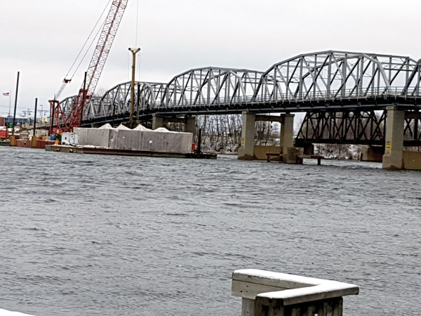 The old bridge was originally constructed in the late 1950s and first opened in 1960. The steel truss bridge will be decommissioned and demolished once the new bridge is complete.