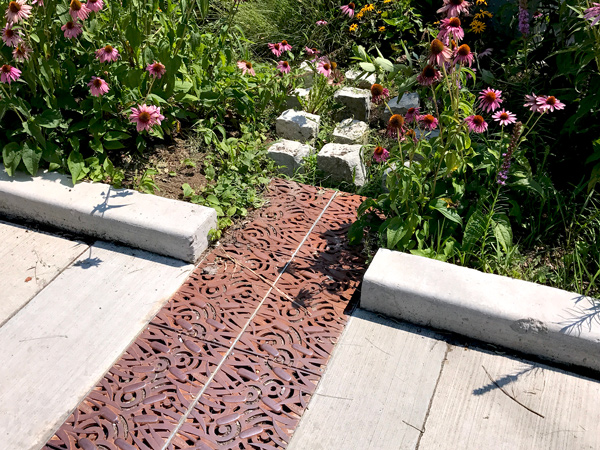 Here is an example of a trench drain at Toronto’s Fairford Parkette. The parkette was created by eliminating a right turn lane and transforming the newly created space into a public parkette which collects and treats stormwater from the road through a trench drain system.