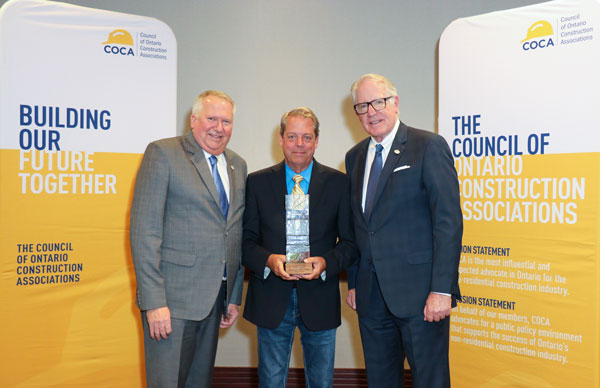 The Council of Ontario Construction Associations presented this year’s Cliff Bulmer Award to Paul Gunning, executive director for the Acoustical Association of Ontario. The award is presented to an individual who has made an outstanding contribution in furthering the relationship between the construction industry and the Ontario Government.