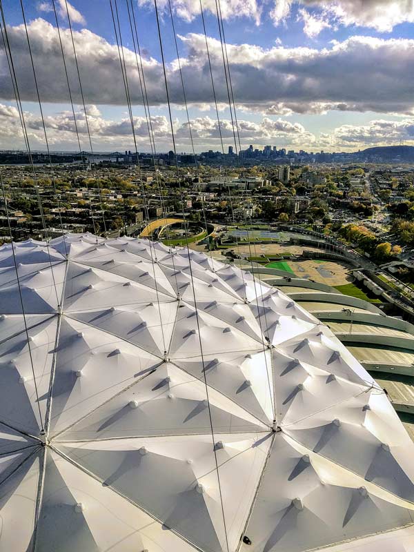 The second roof for the Olympic Stadium in Montreal designed by Birdair is non-retractable and features 93 panels of Teflon covered with fiberglass resting on a lattice of steel cables.