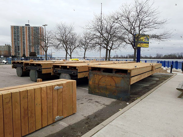 Wooden dock modules supported by steel ballast tubes sit along the Windsor, Ont. shore before installation as part of a new floating marina.