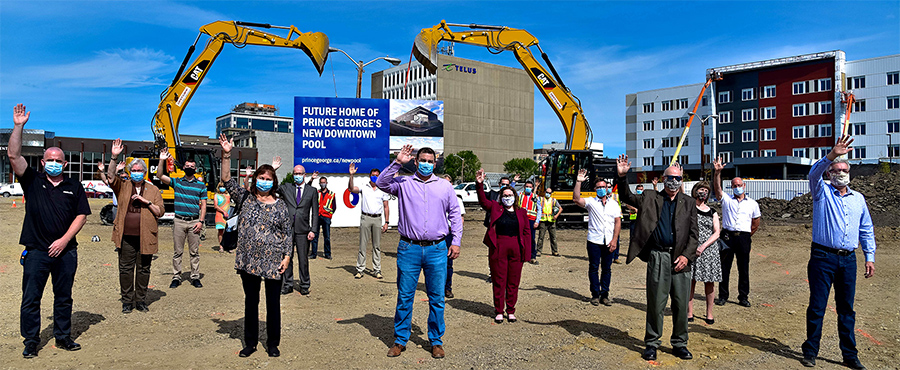 Officials wave during the groundbreaking for a new aquatics centre in downtown Prince George, B.C.